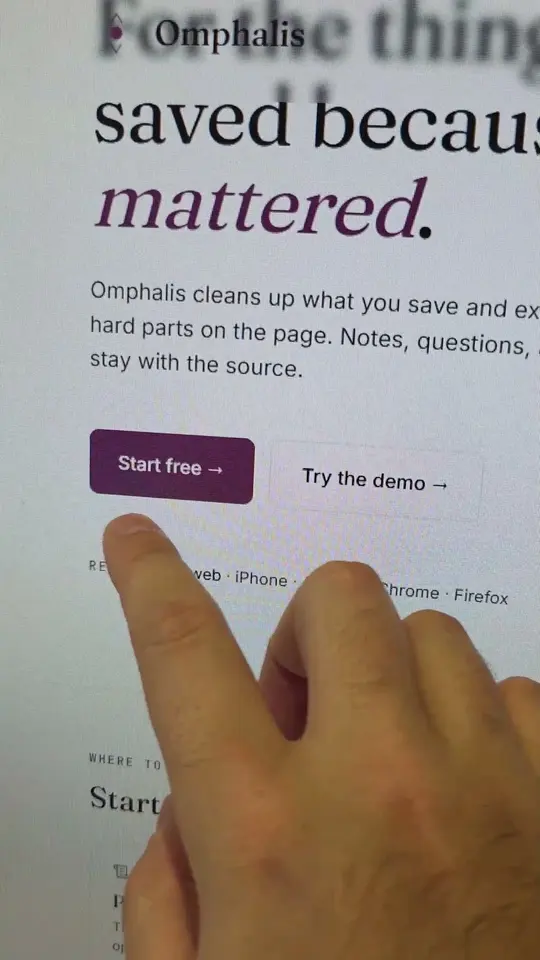 A hand pointing at the Start free button on the Omphalis home page, filmed off a monitor.